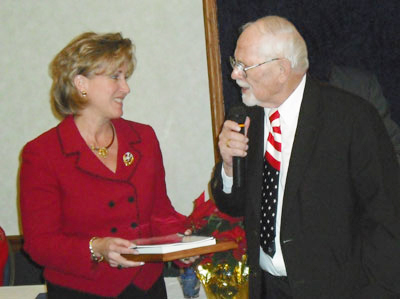 Photo of Kent Stephens presenting certificate of appreciation to Ann Wagner